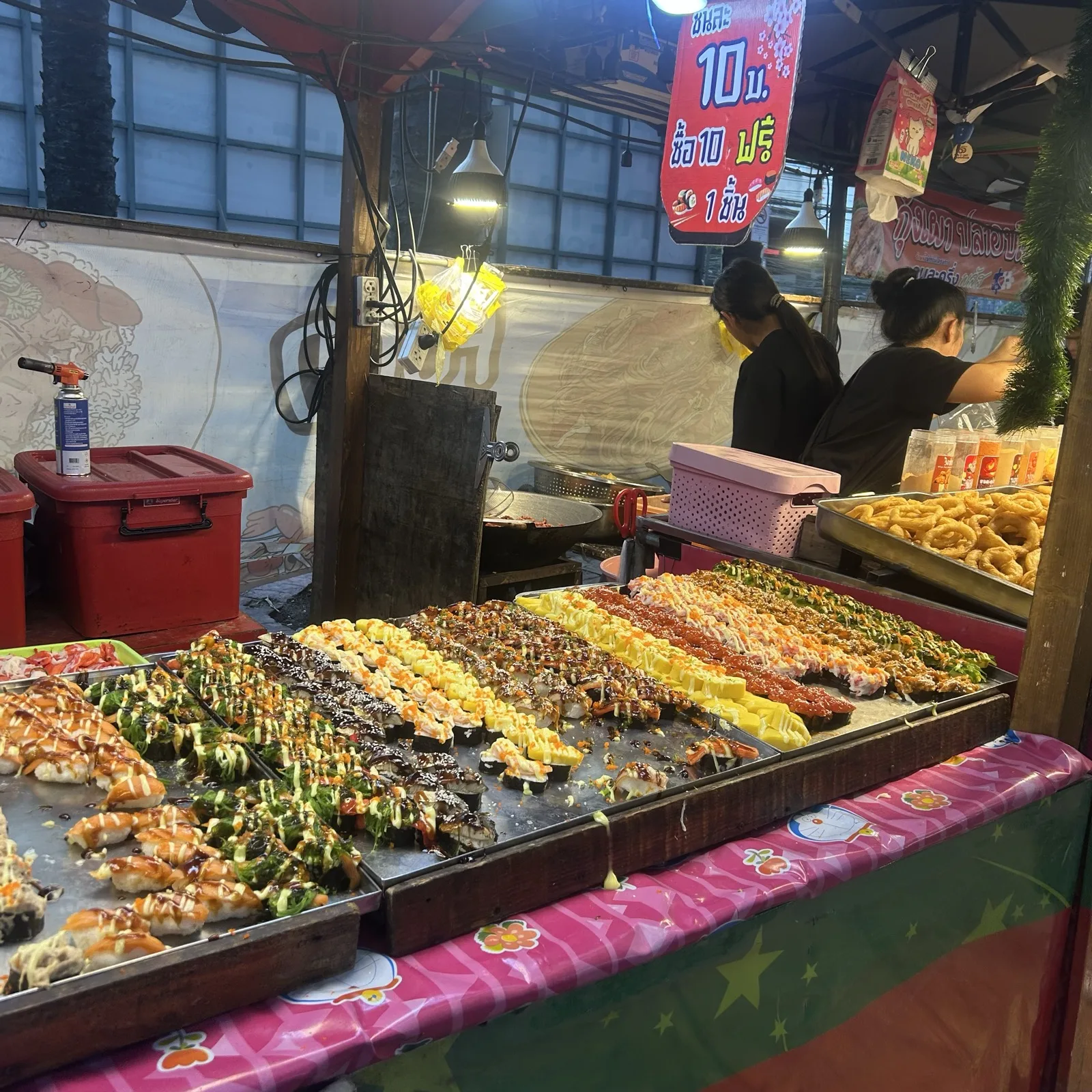 A Pratunam street food stall in Bangkok with grilled seafood and skewers on display